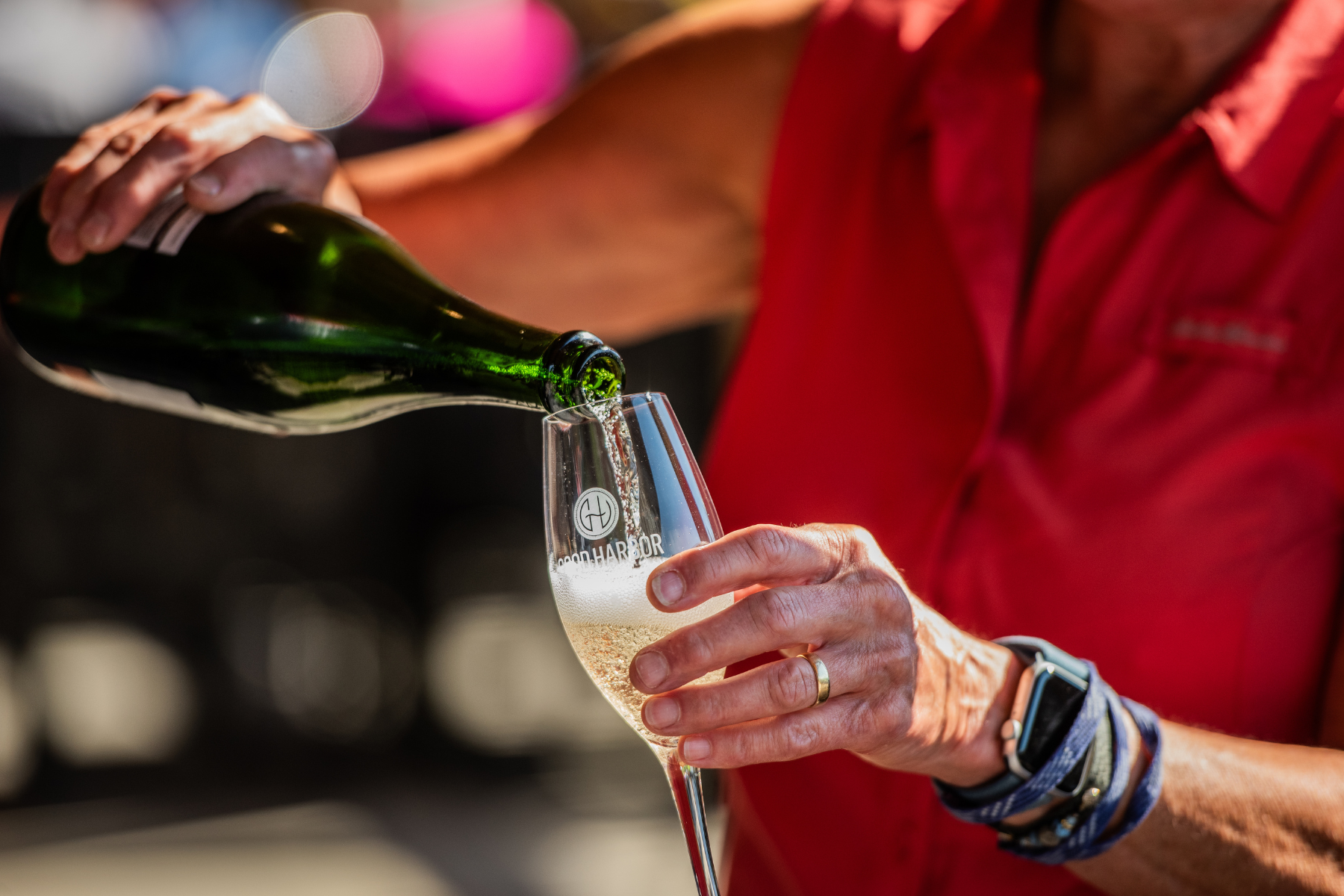 Man serving a Good Harbor Wine in a glass at an event in Lake Leelanau, MI